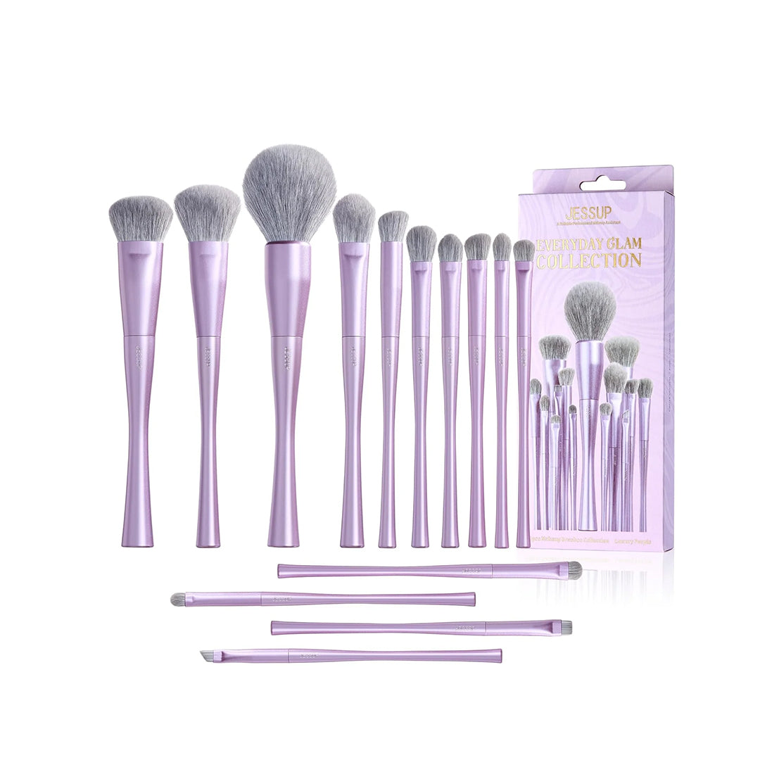 Set of makeup brushes with purple handles and gray bristles, including packaging on a white background.